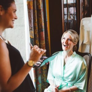 Wedding day makeup - makeup artist applying makeup on bridesmaid