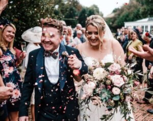 Bride and groom with confetti being thrown. Wedding makeup