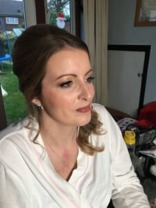 Bride sitting just after makeup being applied. 